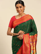 Muniya paithani saree silk blend in bottle green and red with muniya peacock meena butti - closeup view showing fabric and zari work for wedding wear