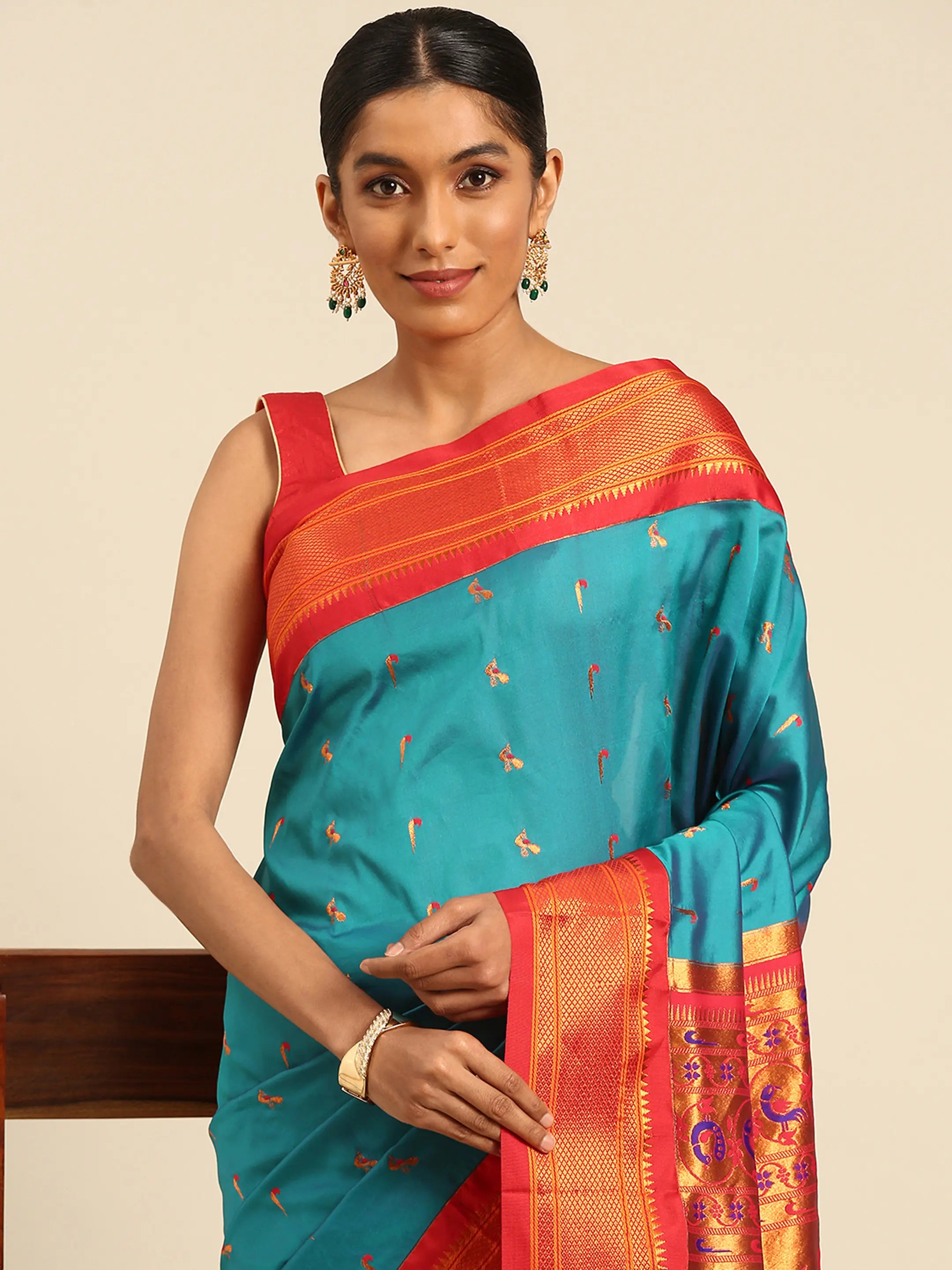 Muniya paithani saree silk blend in rama green and red with muniya peacock meena butti - closeup view showing fabric and zari work for wedding wear