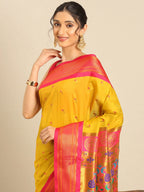 Muniya paithani saree silk blend in mustard yellow and pink with parrot motif zari work - closeup view showing fabric and zari work for wedding wear