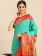 Muniya paithani saree silk blend in sea green and pink with parrot motif zari work - closeup view showing fabric and zari work for wedding wear