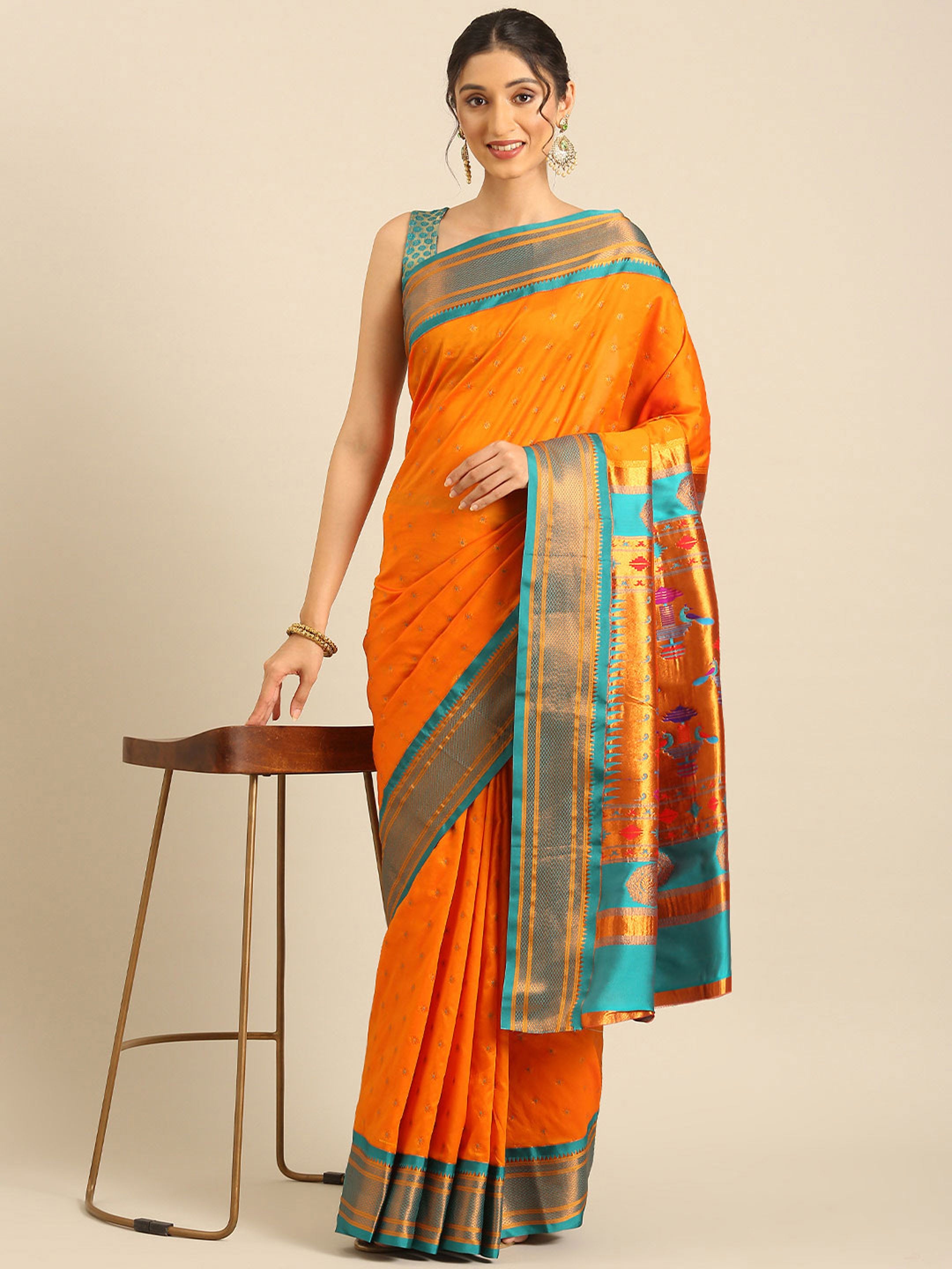 Double pallu paithani saree silk blend in saffron and rama with chakra phool meena butti - styled model view for party wear