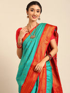 Closeup of Maharani Nauvari Paithani saree silk blend 9 yard Kashta saree in chintamani and red with Paithani design details
