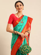 Closeup of Maharani Nauvari Paithani saree silk blend 9 yard Kashta saree in sea green and red with Paithani design details