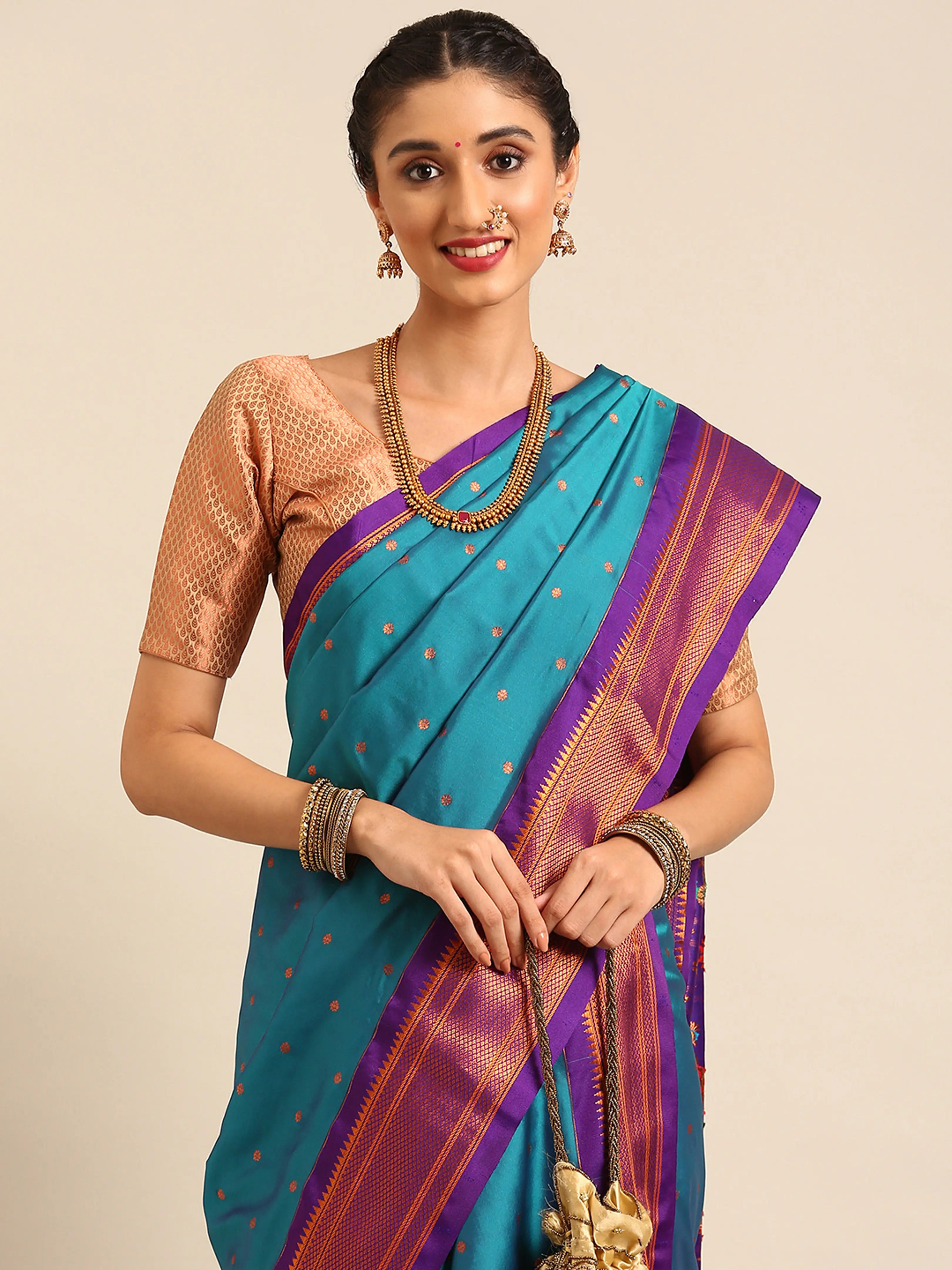 Closeup of Maharani Nauvari Paithani saree silk blend 9 yard Kashta saree in teal blue and violet with Paithani design details